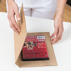 Fold over the cohesive mailer box material over the product..